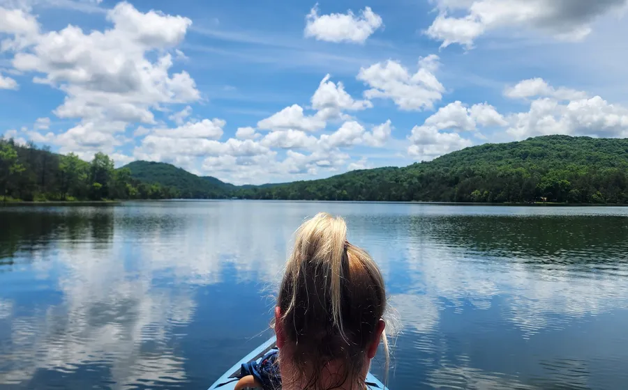 Brittany kayaking under a big sky full of clouds