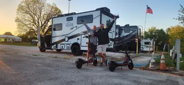Kenny and Brittany with their van and scooters